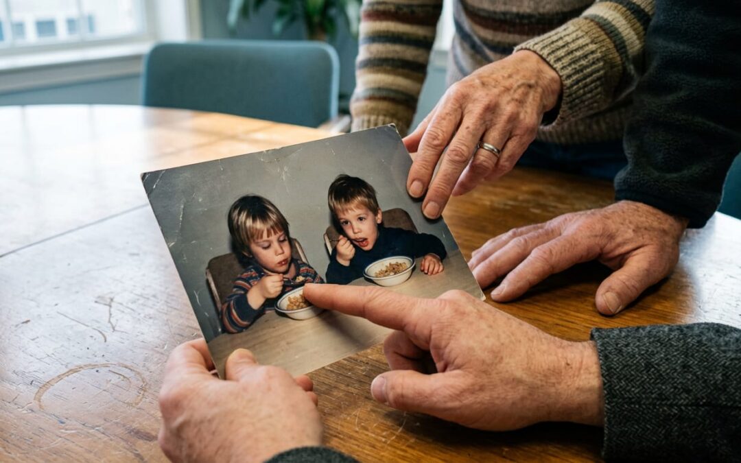 Financial advisor showing a client couple a photo of a Honduras feeding center project during a philanthropy planning meeting.