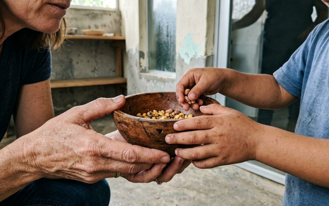 Monthly donor kneeling to connect with two children inside a clean, simple children's home in Honduras during a site visit.